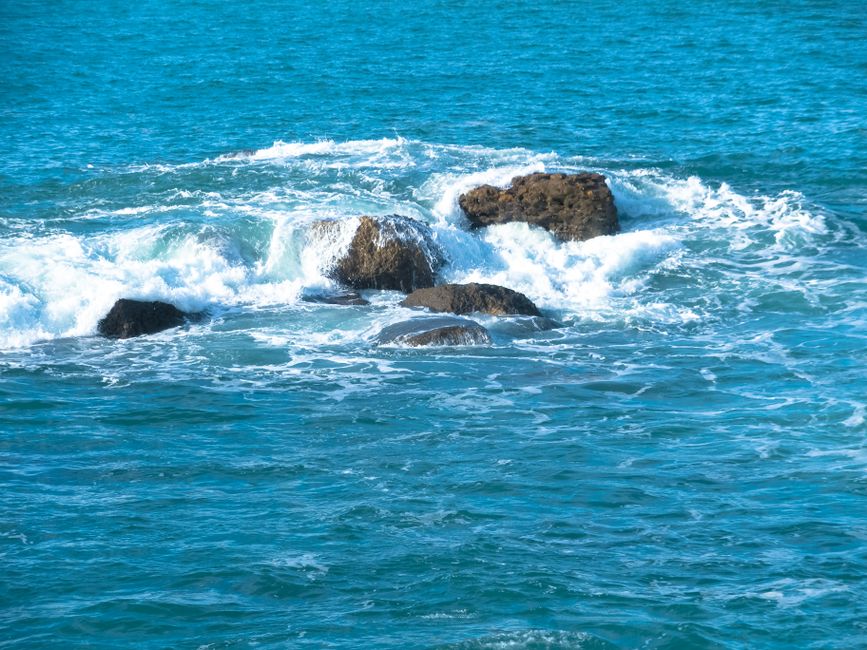 Captivating view of ocean waves crashing on rocky formations, showcasing the sea's power.